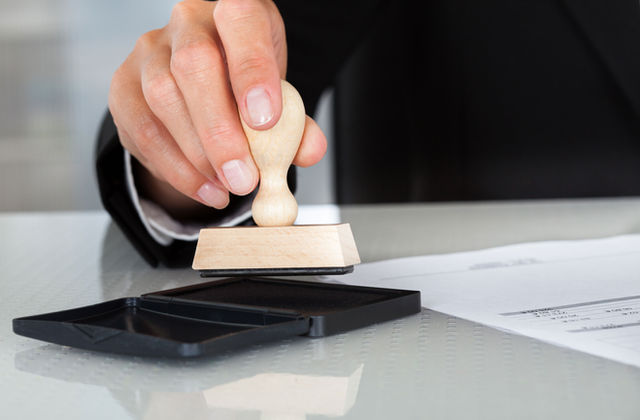 svc-notary Notary public applying a stamp to a document
