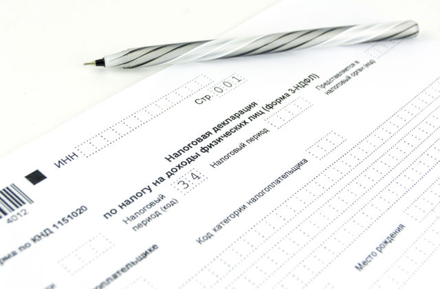 svc-tax Tax return preparation paperwork with a pen